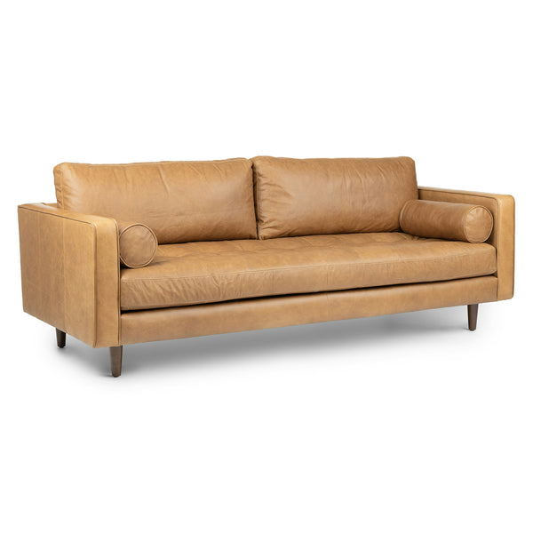 Svening Tufted Oxford Blue leather sofa with bolster pillows in bohemian-style living room