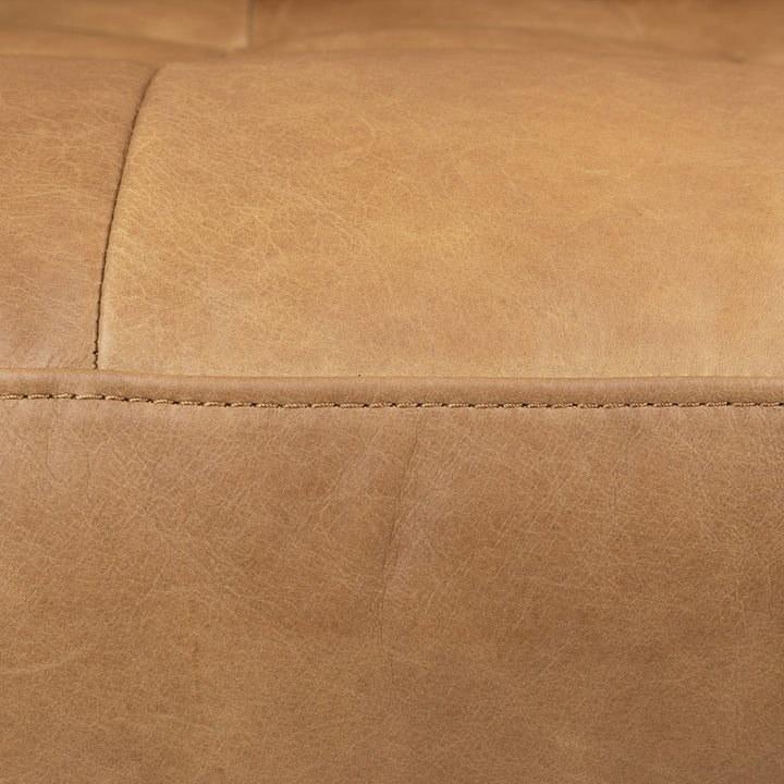 Svening Tufted Tan leather sofa with bolster pillows in bohemian-style living room