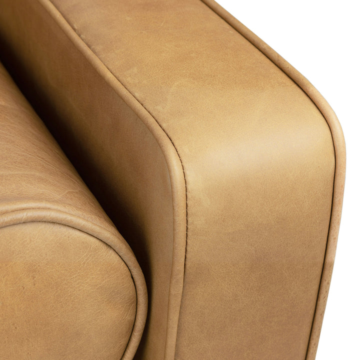 Svening Tufted Tan leather sofa with bolster pillows in bohemian-style living room
