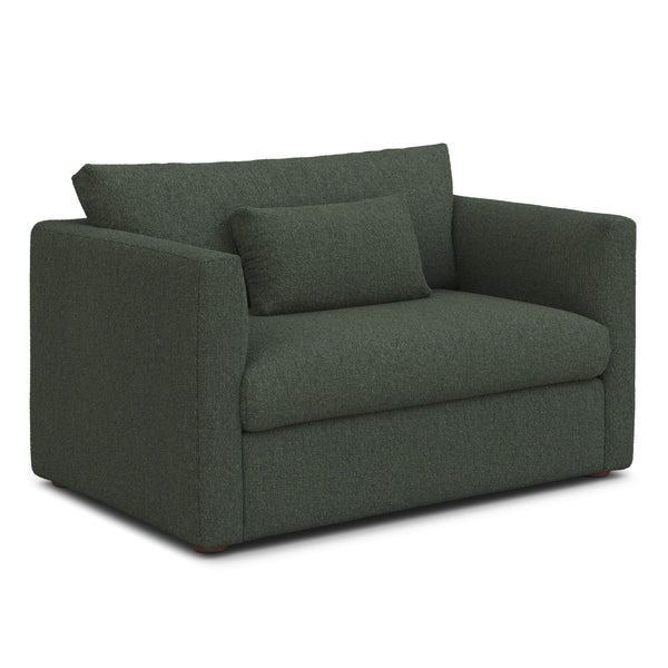 Sylph Sleeper Lounge Chair in navy fabric, converted to bed mode in studio apartment