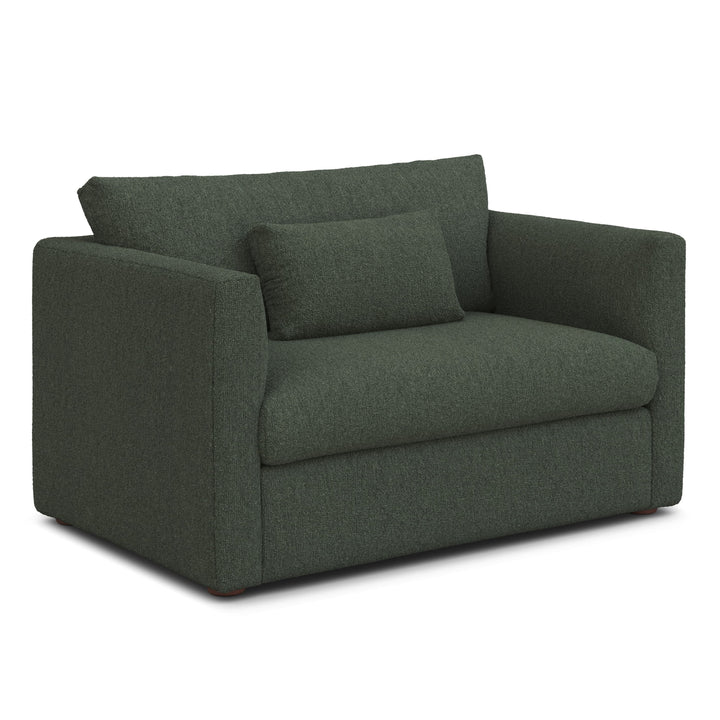 Sylph Sleeper Lounge Chair in navy fabric, converted to bed mode in studio apartment