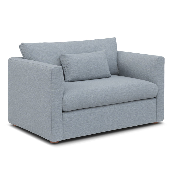 Sylph Sleeper Lounge Chair in light blue fabric, converted to bed mode in studio apartment