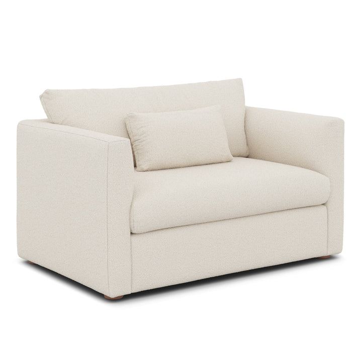 Sylph Sleeper Lounge Chair in white fabric, converted to bed mode in studio apartment