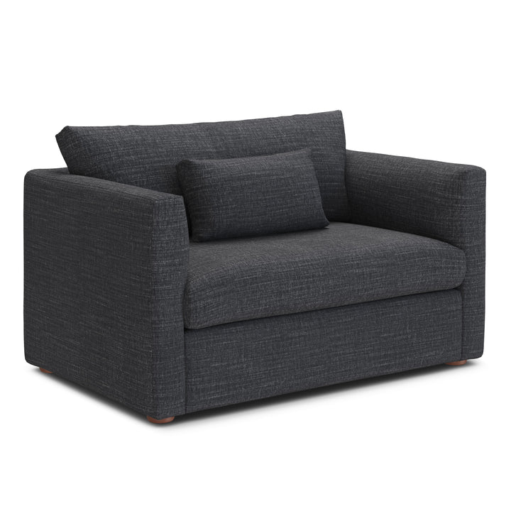 Sylph Sleeper Lounge Chair in Charcoal fabric, converted to bed mode in studio apartment