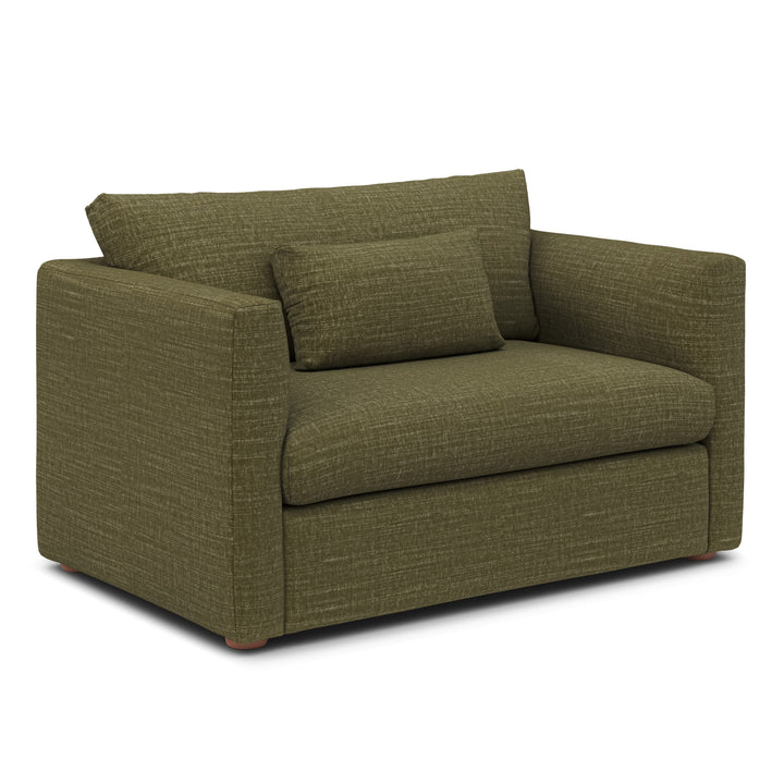 Sylph Sleeper Lounge Chair in Moss fabric, converted to bed mode in studio apartment