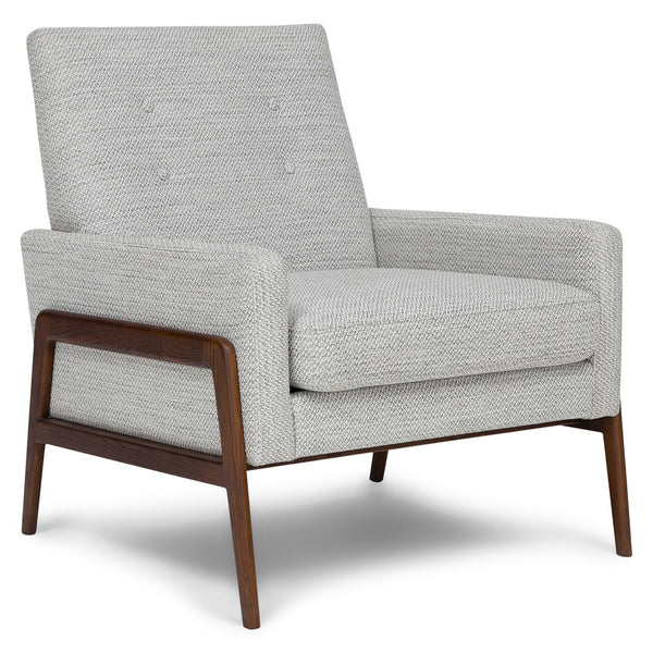Tethys Lounge Chair in storm gray with walnut legs and tufted back in a library setting