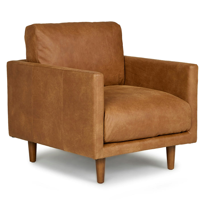 Titan Leather Lounge Chair in aged caramel leather with oak legs in industrial loft