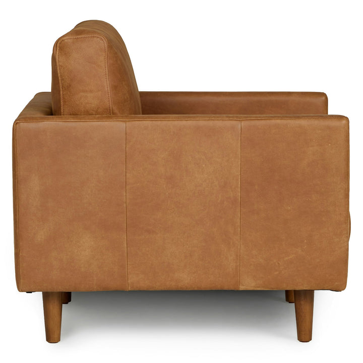 Titan Leather Lounge Chair in aged caramel leather with oak legs in industrial loft