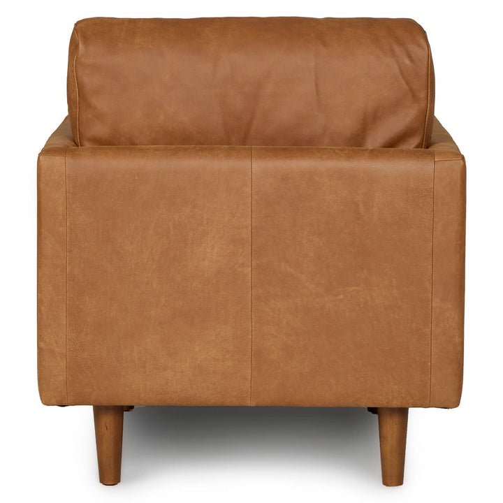 Titan Leather Lounge Chair in aged caramel leather with oak legs in industrial loft