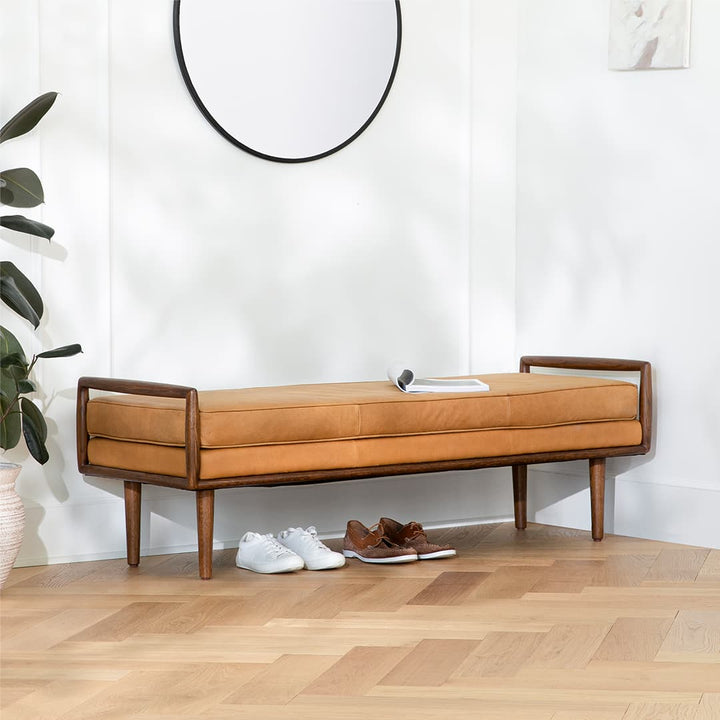 Vatn Leather Bench in a mid-century modern living room with walnut arms and tapered legs