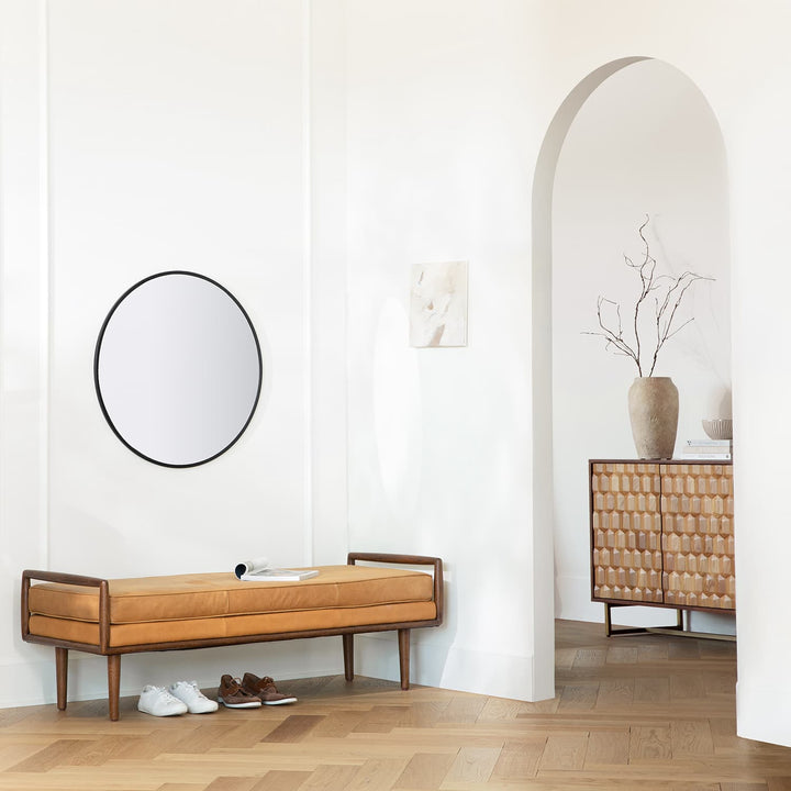 Vatn Leather Bench in a mid-century modern living room with walnut arms and tapered legs