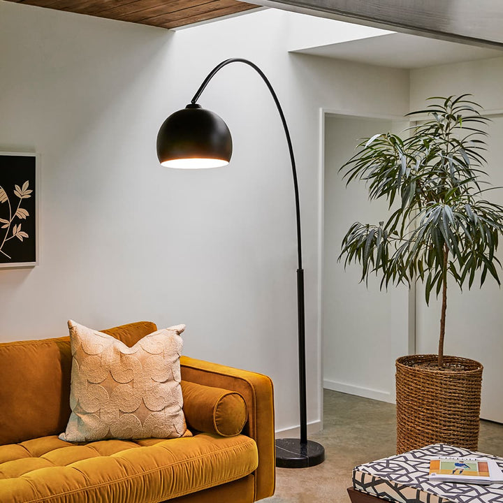 Vega Floor Lamp in a modern living room with crescent arc and marble base