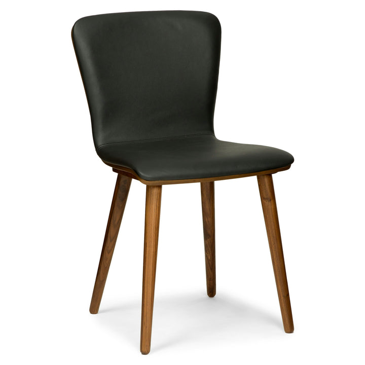 Vela Dining Chairs in a mid-century modern dining room with Toscana leather and tapered legs