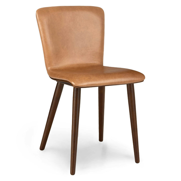 Vela Dining Chairs in a mid-century modern dining room with Toscana leather and tapered legs