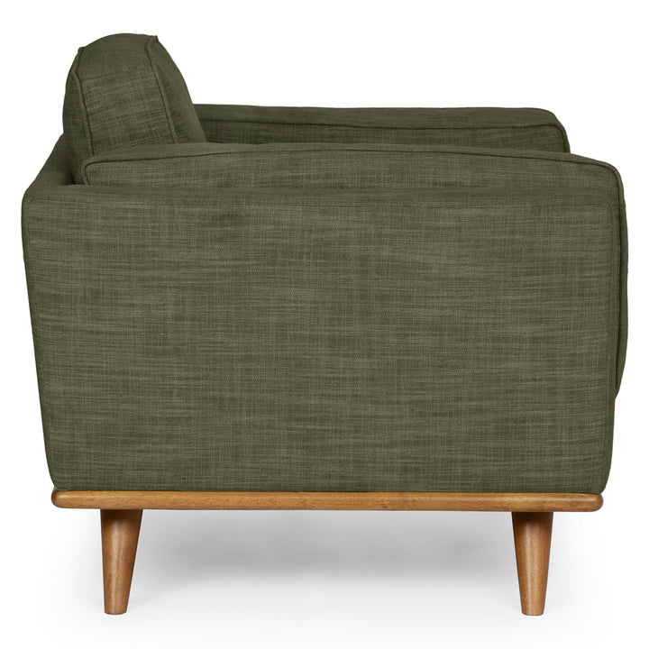 Ventura Lounge Chair in oat bouclé fabric with plush cushions, placed by a sunny window with coffee mug on side table