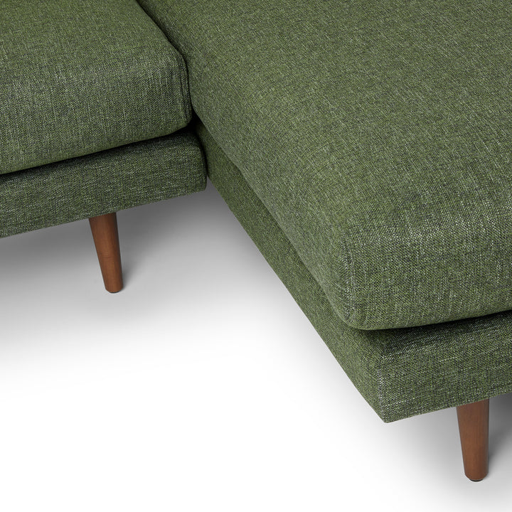 Winters Right green sectional with tapered legs in mid-century modern loft
