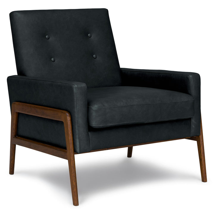 Zephyr Black Leather Lounge Chair in aged patina beside family photo album on oak side table