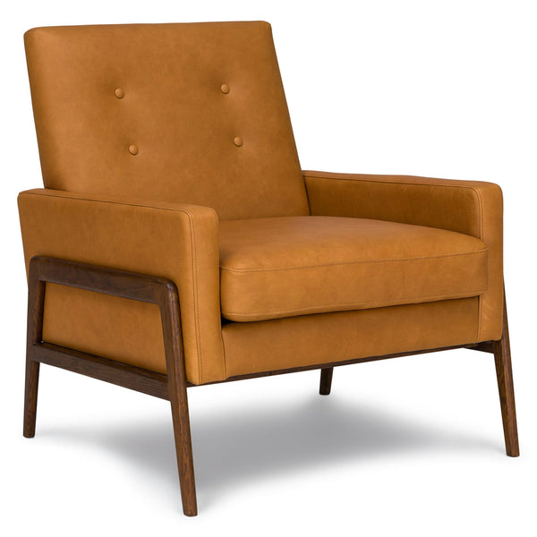 Zephyr Tan Leather Lounge Chair in aged patina beside family photo album on oak side table