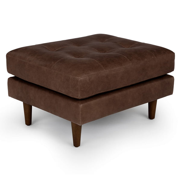 Æon Leather Ottoman in a modern living room with tufted Taos leather and bolster pillows